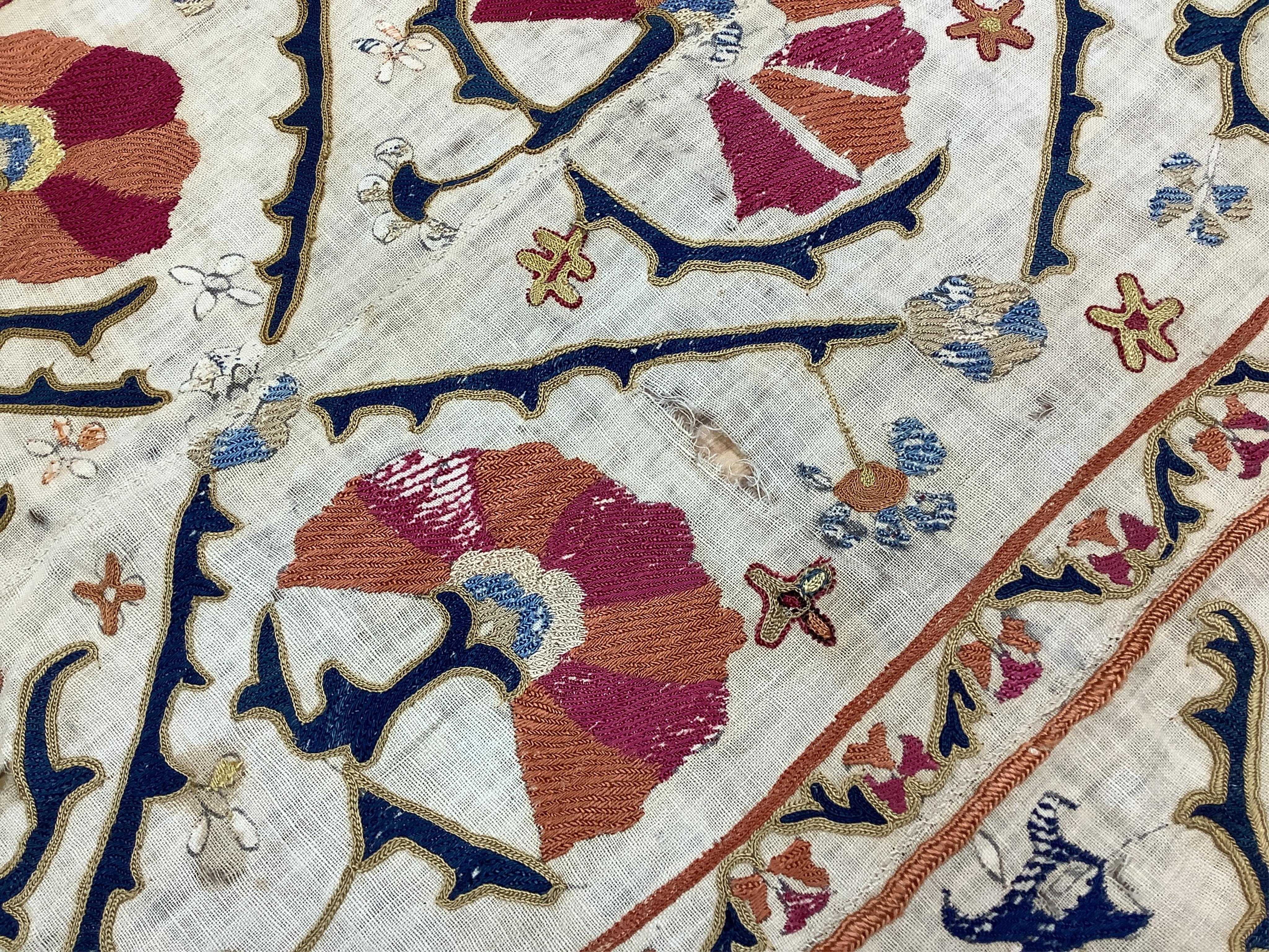 A 19th century Uzbekistan Suzani, hand embroidered hanging. Made from hand woven linen panels each approximately 28cm wide x 167cm long. Hand embroidered with silk hand dyed threads, in orange, red, blue and yellows, usi